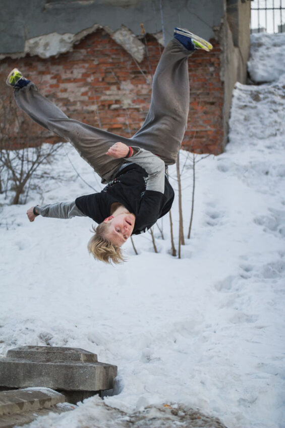 Backflip parkour in winter snow park – blonde hair teenager